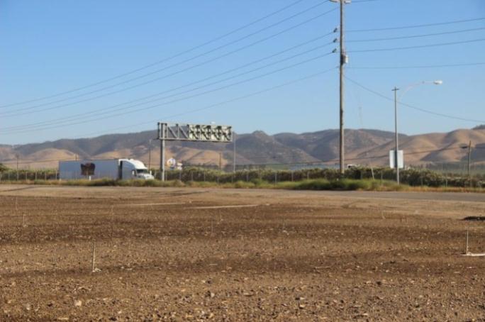 A highway with a large truck driving down it.